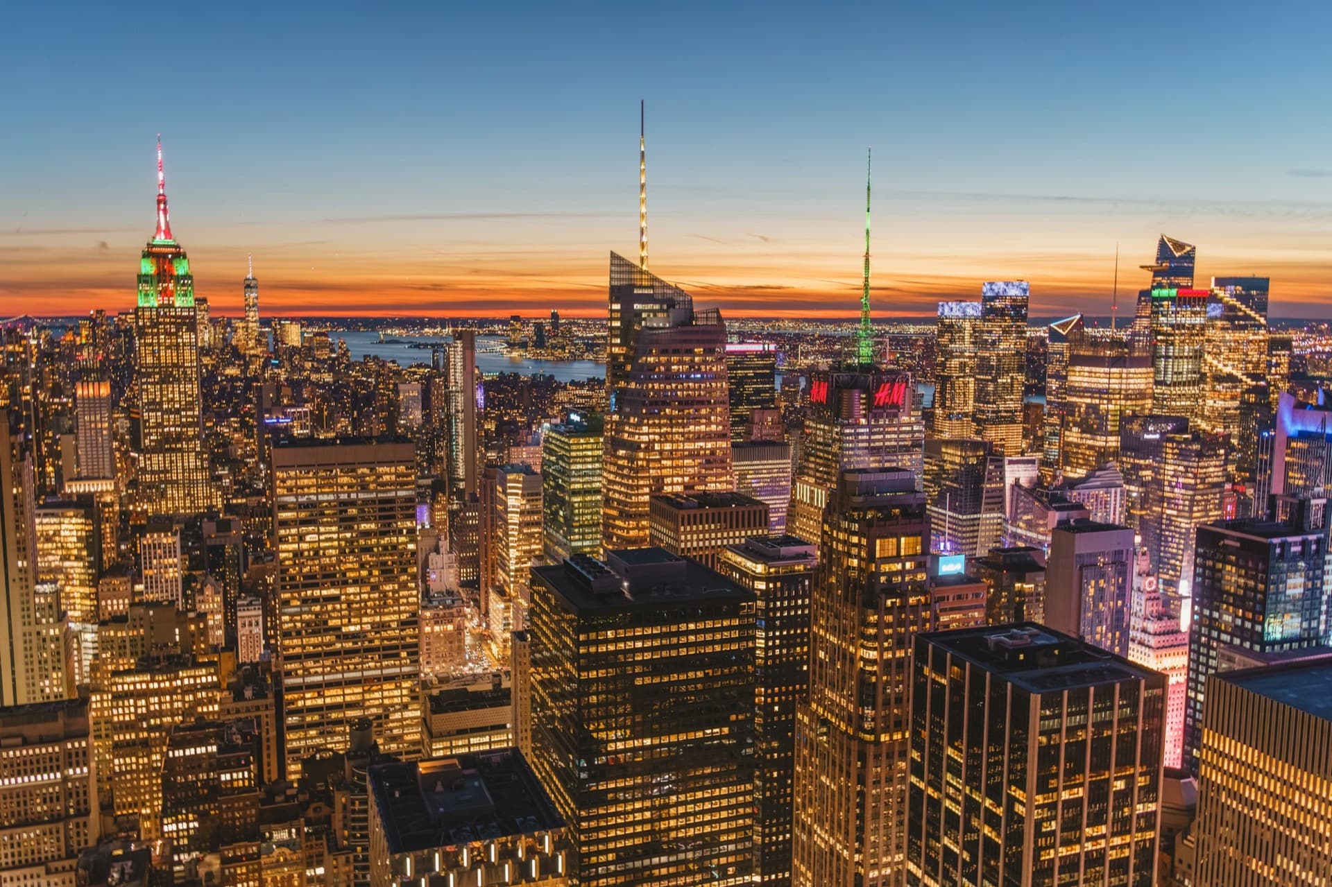 Manhattan skyline lit up at dusk