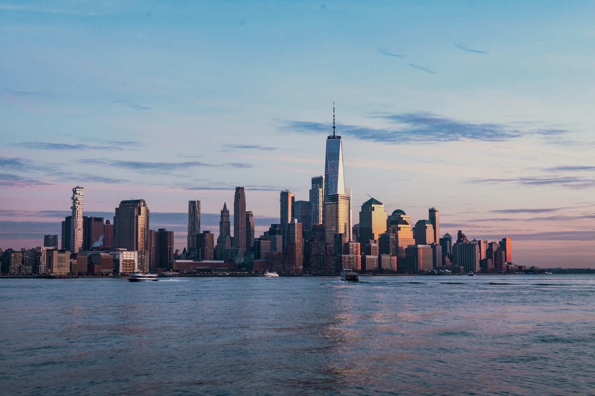 Lower Manhattan skyline across the Hudson River at sunset