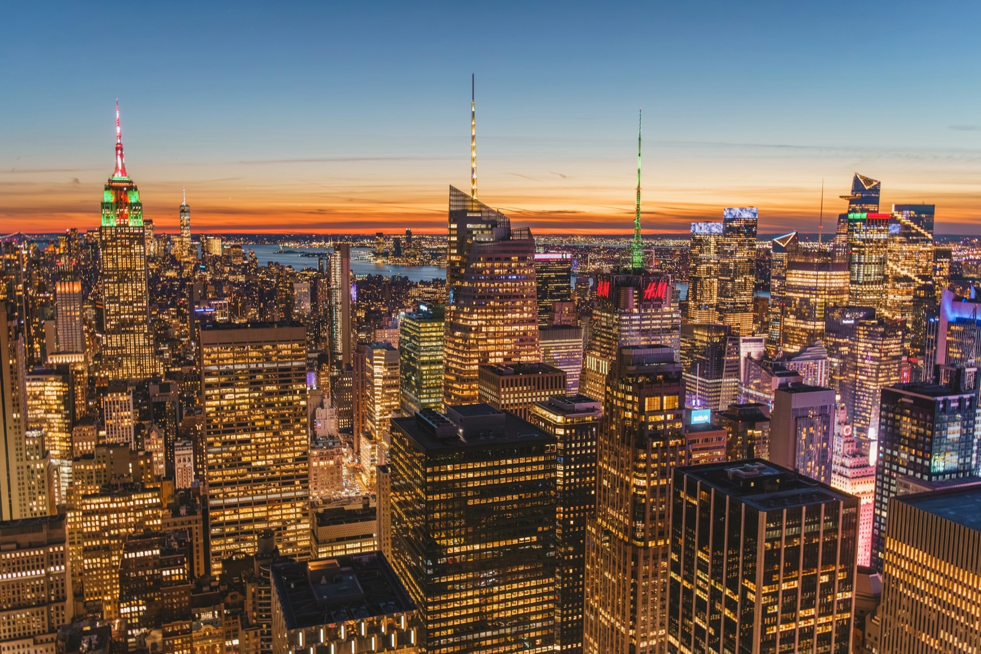 Manhattan skyline lit up at dusk